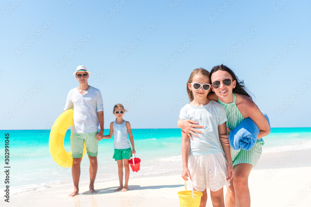 Happy beautiful family with kids on the beach Happy beautiful family with kids on the beach