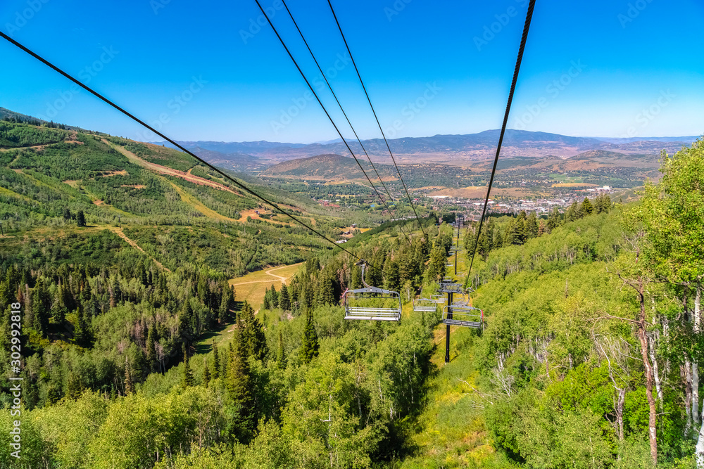 Chairlifts and aerial view of mountain hiking trails and buildings in summer Chairlifts and aerial view of mountain hiking trails and buildings in summer