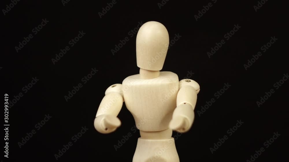 wooden doll on black background rotates 360 degrees. wooden doll on black background rotates 360 degrees.