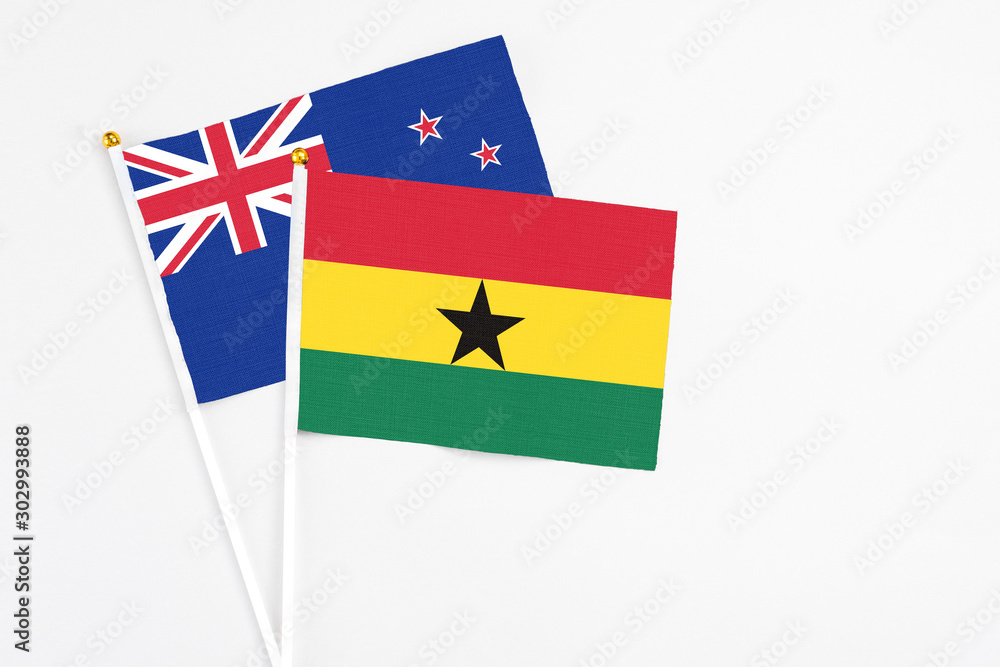 Ghana and New Zealand stick flags on white background. High quality fabric, miniature national flag. Peaceful global concept.White floor for copy space. Ghana and New Zealand stick flags on white background. High quality fabric, miniature national flag. Peaceful global concept.White floor for copy space.