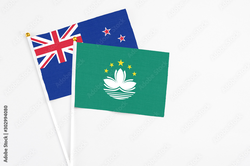 Macao and New Zealand stick flags on white background. High quality fabric, miniature national flag. Peaceful global concept.White floor for copy space. Macao and New Zealand stick flags on white background. High quality fabric, miniature national flag. Peaceful global concept.White floor for copy space.