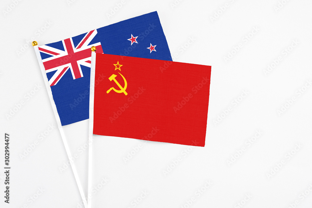 Soviet Union and New Zealand stick flags on white background. High quality fabric, miniature national flag. Peaceful global concept.White floor for copy space. Soviet Union and New Zealand stick flags on white background. High quality fabric, miniature national flag. Peaceful global concept.White floor for copy space.