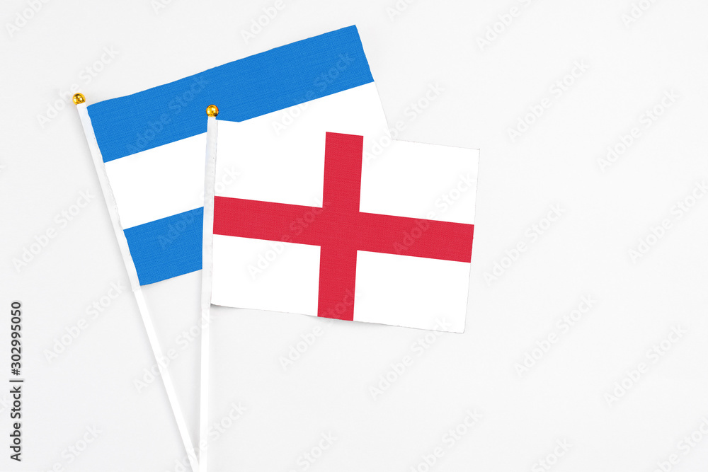 England and Nicaragua stick flags on white background. High quality fabric, miniature national flag. Peaceful global concept.White floor for copy space.