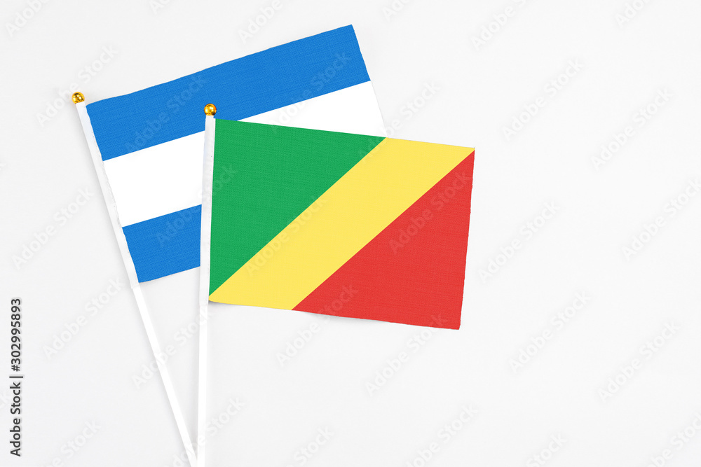Republic Of The Congo and Nicaragua stick flags on white background. High quality fabric, miniature national flag. Peaceful global concept.White floor for copy space. Republic Of The Congo and Nicaragua stick flags on white background. High quality fabric, miniature national flag. Peaceful global concept.White floor for copy space.