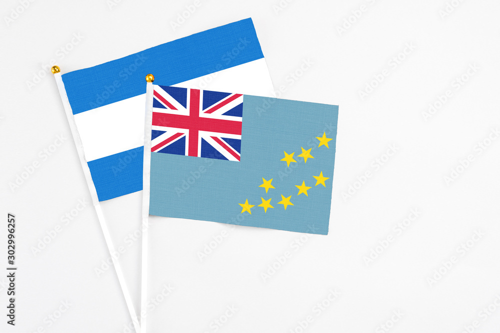 Fototapeta premium Tuvalu and Nicaragua stick flags on white background. High quality fabric, miniature national flag. Peaceful global concept.White floor for copy space.