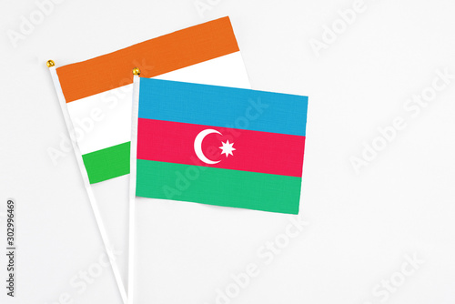 Free Download Azerbaijan and Niger stick flags on white background. High quality fabric, miniature national flag. Peaceful global concept.White floor for copy space. - GFXLoad