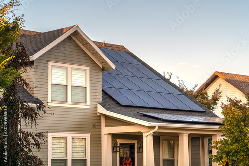 Solar photovoltaic panels on a house roof © Jason