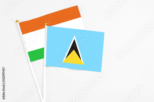 Free Download Saint Lucia and Niger stick flags on white background. High quality fabric, miniature national flag. Peaceful global concept.White floor for copy space. - GFXLoad