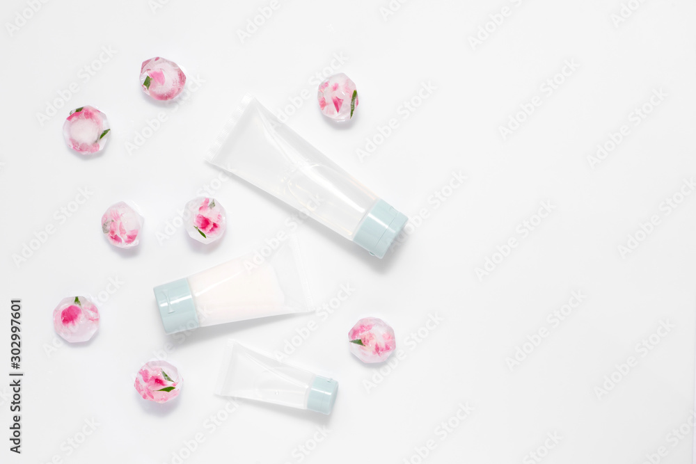 Recipe of youth, face care treatment, cream transparent tubes, ice cubes with herbs and flowers isolated on white background. Flat lay, top view, copy space. Beauty therapy products concept Recipe of youth, face care treatment, cream transparent tubes, ice cubes with herbs and flowers isolated on white background. Flat lay, top view, copy space. Beauty therapy products concept