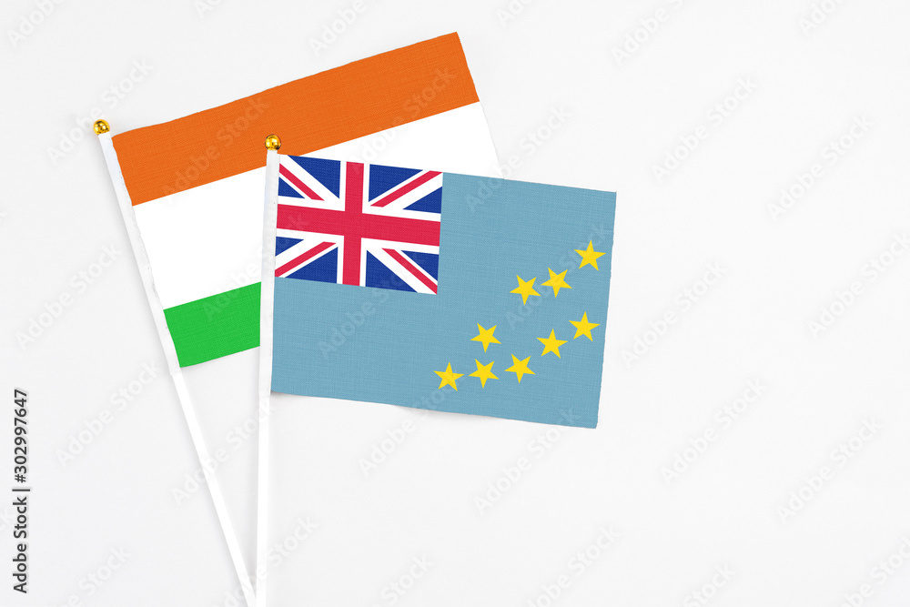 Tuvalu and Niger stick flags on white background. High quality fabric, miniature national flag. Peaceful global concept.White floor for copy space. Tuvalu and Niger stick flags on white background. High quality fabric, miniature national flag. Peaceful global concept.White floor for copy space.