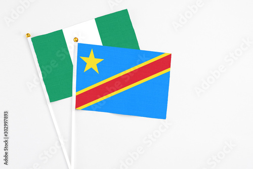 Congo and Nigeria stick flags on white background. High quality fabric  miniature national flag. Peaceful global concept.White floor for copy space.