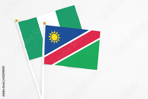 Namibia and Nigeria stick flags on white background. High quality fabric, miniature national flag. Peaceful global concept.White floor for copy space. Free Download Namibia and Nigeria stick flags on white background. High quality fabric, miniature national flag. Peaceful global concept.White floor for copy space. - GFXLoad