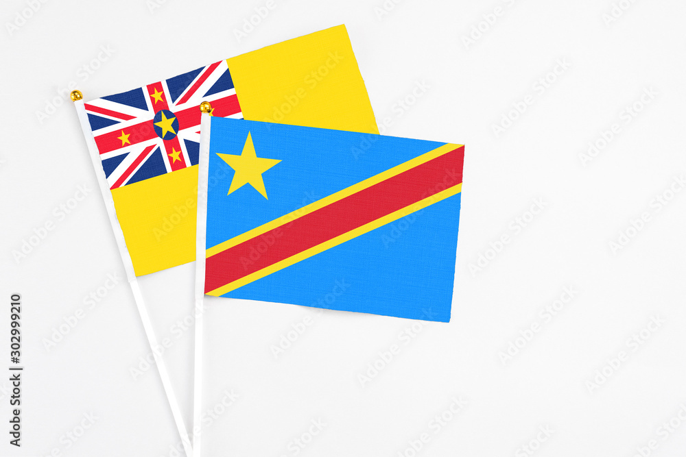 Congo and Niue stick flags on white background. High quality fabric, miniature national flag. Peaceful global concept.White floor for copy space. Congo and Niue stick flags on white background. High quality fabric, miniature national flag. Peaceful global concept.White floor for copy space.