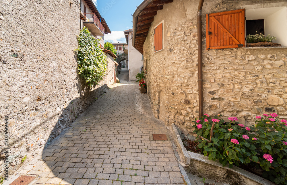 Narrow street of mountain ancient village Zelbio, Italy