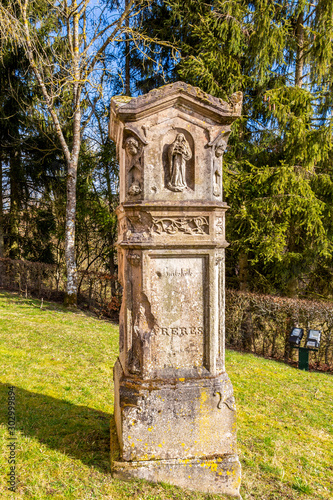 Beautiful old tombstone in the churchyard of the Church of St. Maximin, village of Pintsch, Commune of Kiischpelt, Northern Luxembourg photo