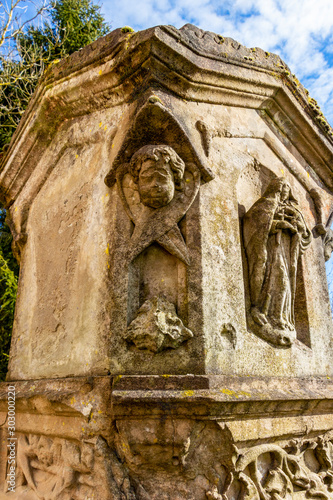 Beautiful old tombstone in the churchyard of the Church of St. Maximin, village of Pintsch, Commune of Kiischpelt, Northern Luxembourg, detail photo