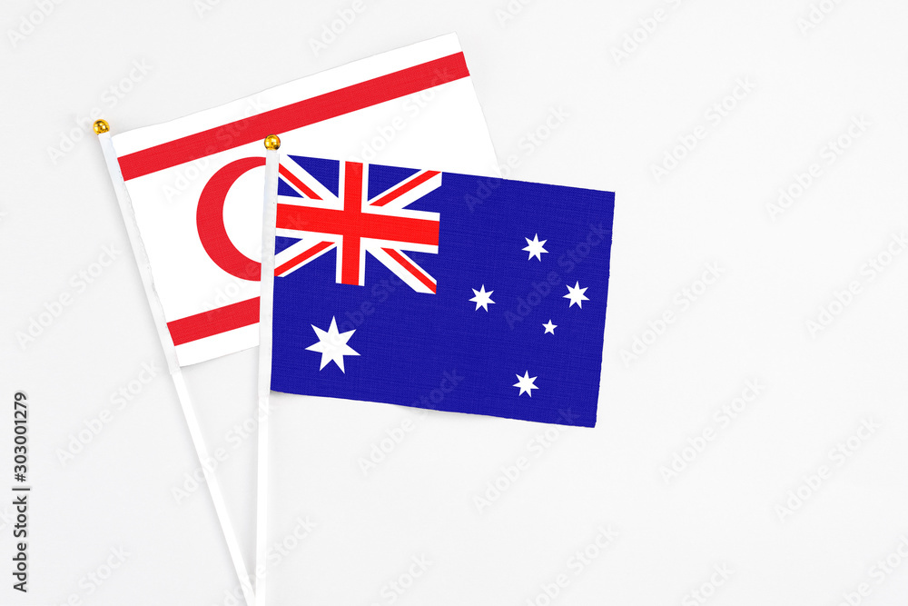 Fototapeta premium Australia and Northern Cyprus stick flags on white background. High quality fabric, miniature national flag. Peaceful global concept.White floor for copy space.
