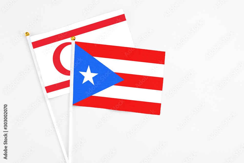 Puerto Rico and Northern Cyprus stick flags on white background. High quality fabric, miniature national flag. Peaceful global concept.White floor for copy space. Puerto Rico and Northern Cyprus stick flags on white background. High quality fabric, miniature national flag. Peaceful global concept.White floor for copy space.