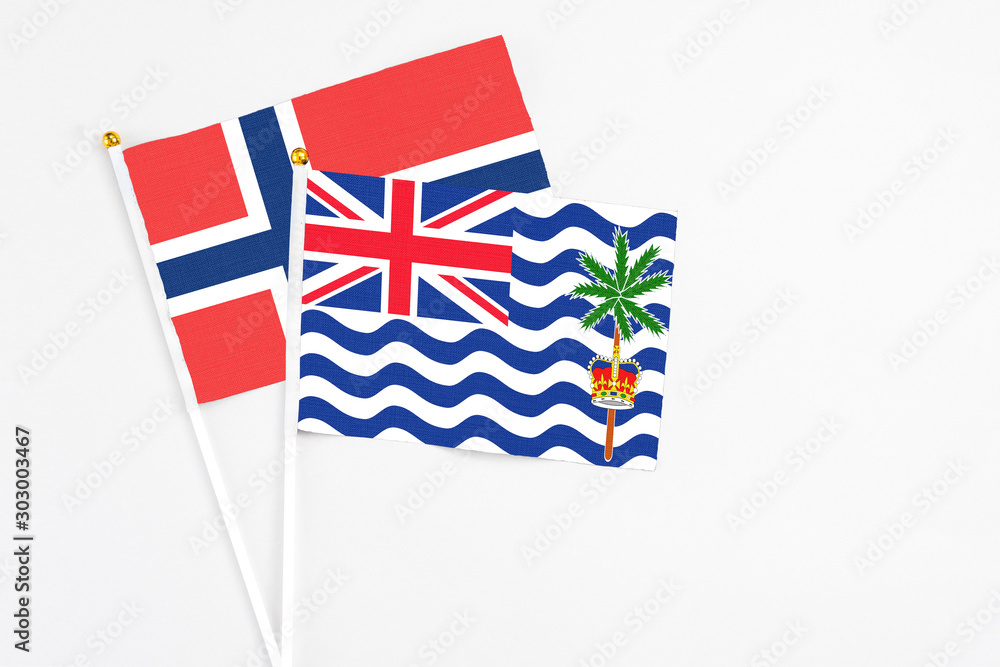 Fototapeta premium British Indian Ocean Territory and Norway stick flags on white background. High quality fabric, miniature national flag. Peaceful global concept.White floor for copy space.
