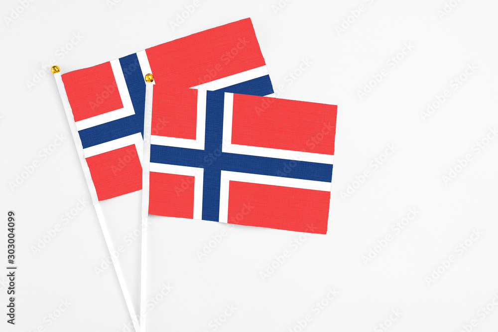 Norway and Norway stick flags on white background. High quality fabric, miniature national flag. Peaceful global concept.White floor for copy space.