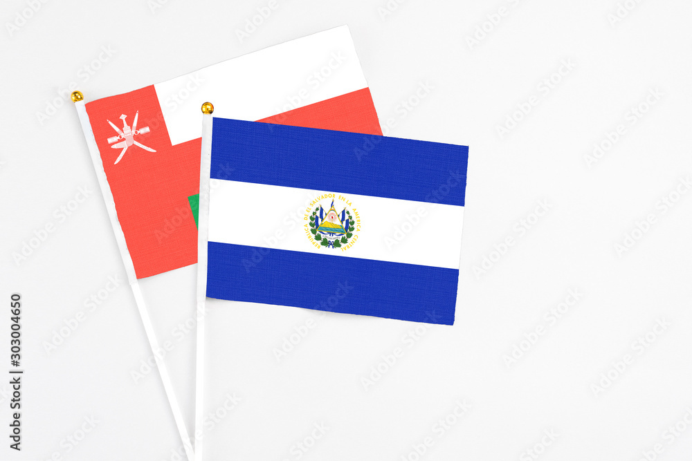 El Salvador and Oman stick flags on white background. High quality fabric, miniature national flag. Peaceful global concept.White floor for copy space. El Salvador and Oman stick flags on white background. High quality fabric, miniature national flag. Peaceful global concept.White floor for copy space.