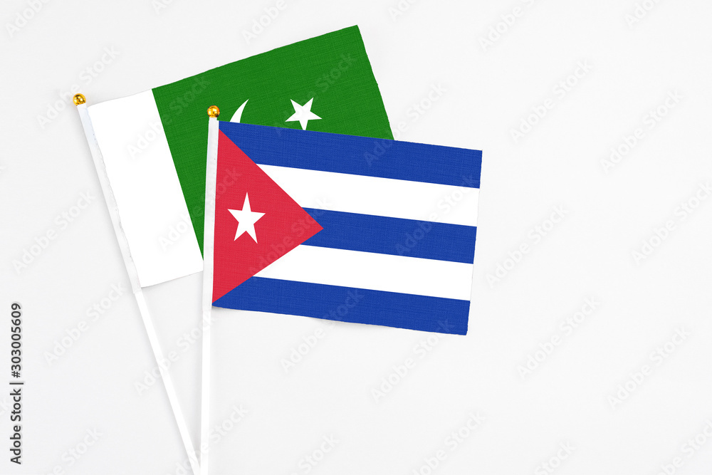 Cuba and Pakistan stick flags on white background. High quality fabric, miniature national flag. Peaceful global concept.White floor for copy space. Cuba and Pakistan stick flags on white background. High quality fabric, miniature national flag. Peaceful global concept.White floor for copy space.