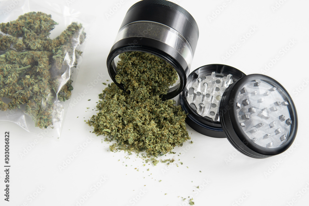 Weed grinder Fresh marihuana. Cannabis buds on white wood background. Copy  space. Close up. Blunt and Lighters. CBD and THC on buds in cannabis. foto  de Stock