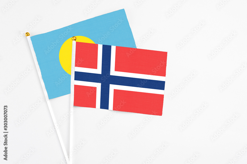Norway and Palau stick flags on white background. High quality fabric, miniature national flag. Peaceful global concept.White floor for copy space. Norway and Palau stick flags on white background. High quality fabric, miniature national flag. Peaceful global concept.White floor for copy space.