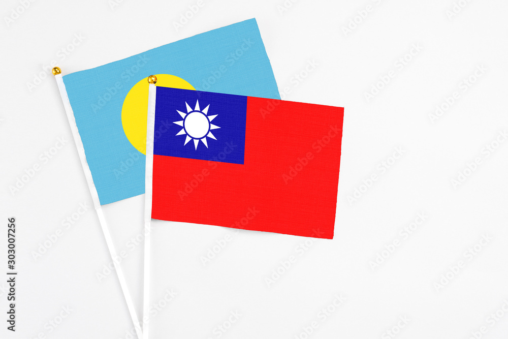 Taiwan and Palau stick flags on white background. High quality fabric, miniature national flag. Peaceful global concept.White floor for copy space. Taiwan and Palau stick flags on white background. High quality fabric, miniature national flag. Peaceful global concept.White floor for copy space.
