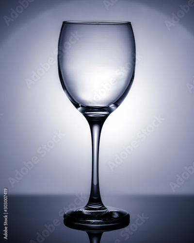 Empty wineglass in blue. Object photography.