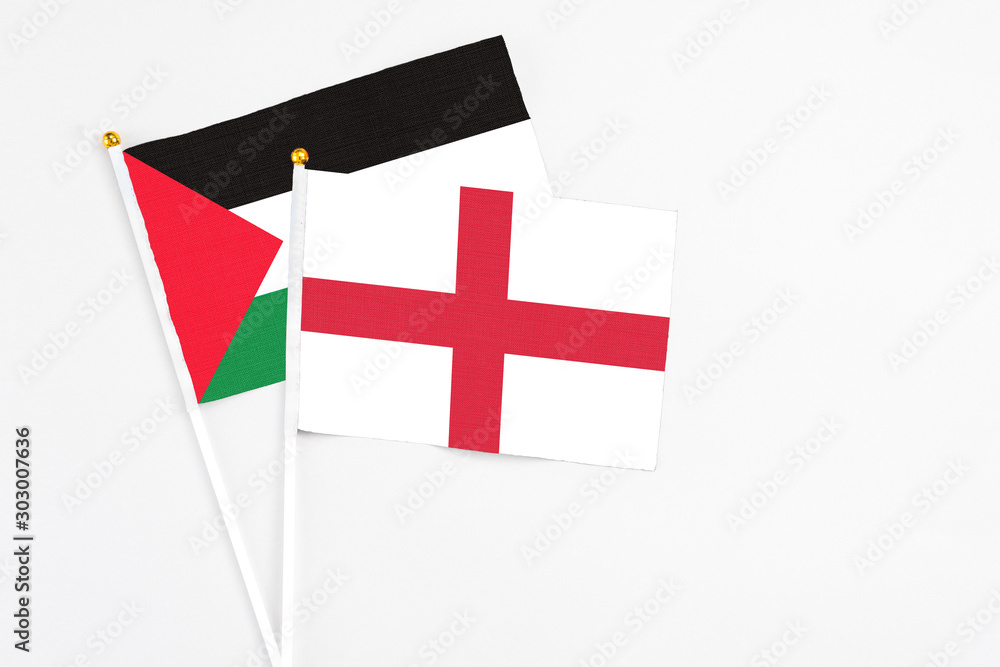England and Palestine stick flags on white background. High quality fabric, miniature national flag. Peaceful global concept.White floor for copy space.