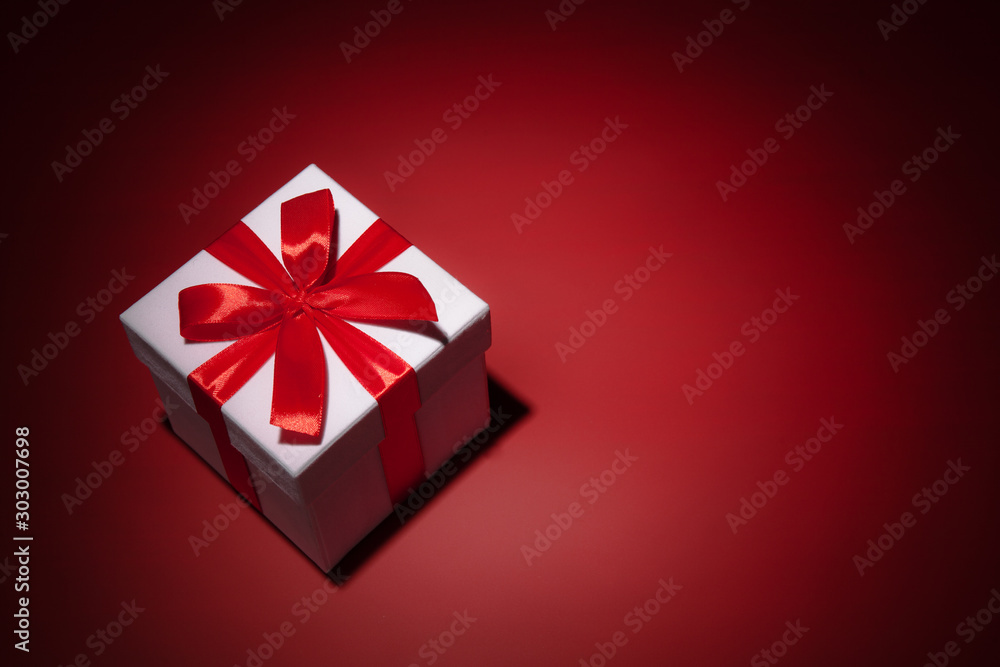 White gift box on red background. Copy spase White gift box on red background. Copy spase