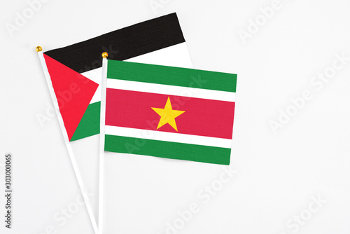Suriname and Palestine stick flags on white background. High quality fabric, miniature national flag. Peaceful global concept.White floor for copy space. Free Download Suriname and Palestine stick flags on white background. High quality fabric, miniature national flag. Peaceful global concept.White floor for copy space. - GFXLoad