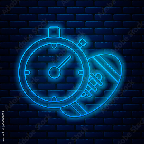 Glowing neon line American Football ball and stopwatch icon isolated on brick wall background. Set of sport equipment. Vector Illustration