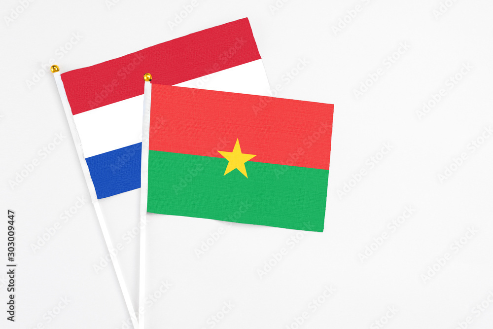 Burkina Faso and Paraguay stick flags on white background. High quality fabric, miniature national flag. Peaceful global concept.White floor for copy space. Burkina Faso and Paraguay stick flags on white background. High quality fabric, miniature national flag. Peaceful global concept.White floor for copy space.