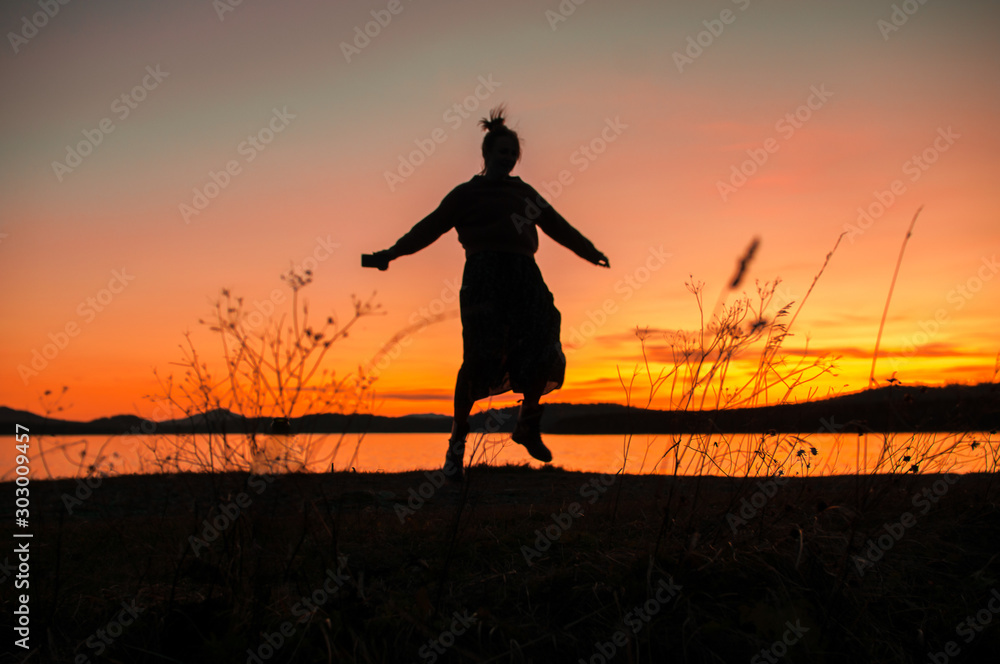 silhouette of a girl dancing on the background of a beautiful sunset silhouette of a girl dancing on the background of a beautiful sunset