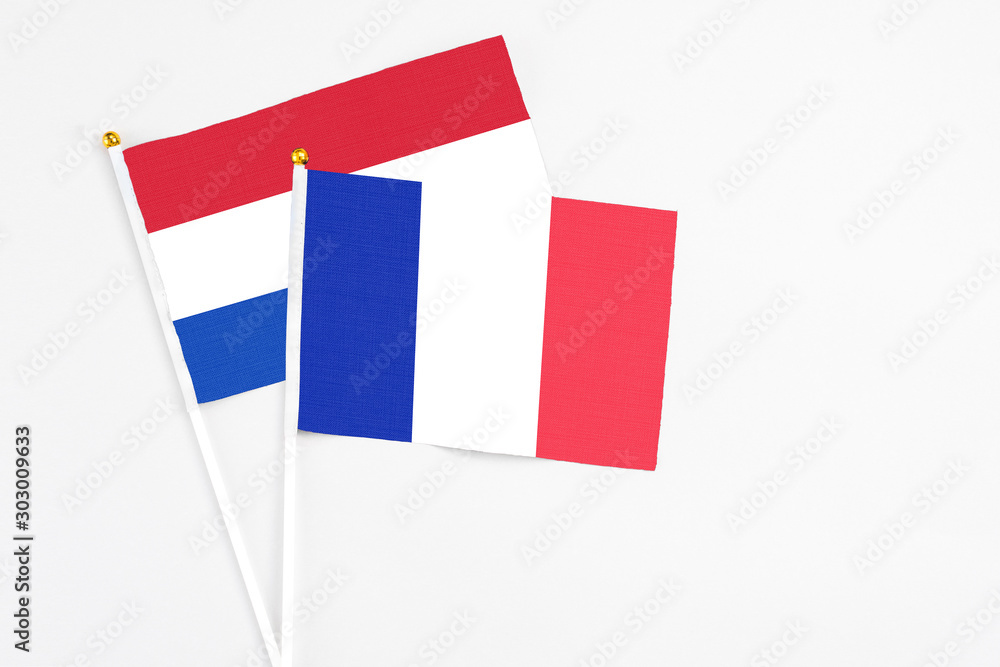 France and Paraguay stick flags on white background. High quality fabric, miniature national flag. Peaceful global concept.White floor for copy space. France and Paraguay stick flags on white background. High quality fabric, miniature national flag. Peaceful global concept.White floor for copy space.
