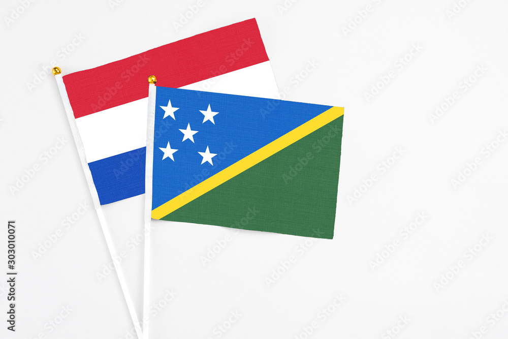 Solomon Islands and Paraguay stick flags on white background. High quality fabric, miniature national flag. Peaceful global concept.White floor for copy space. Solomon Islands and Paraguay stick flags on white background. High quality fabric, miniature national flag. Peaceful global concept.White floor for copy space.