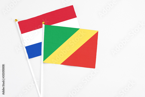 Free Download Republic Of The Congo and Paraguay stick flags on white background. High quality fabric, miniature national flag. Peaceful global concept.White floor for copy space. - GFXLoad
