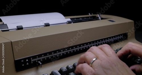 ECU OF FEMALE HANDS USING A VINTAGE ELECTRIC TYPEWRITER.  C4K, 10 BIT, ALL-INTRA CODEC