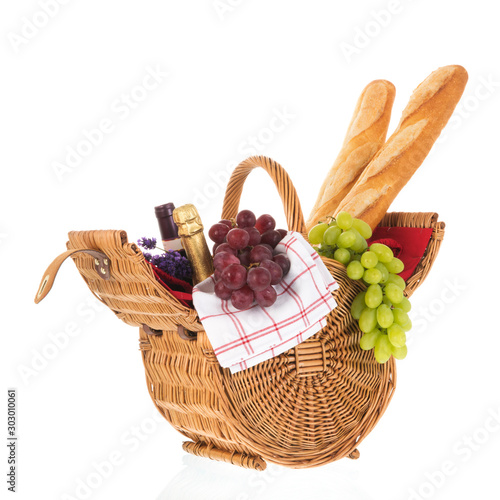 Picnic basket with bread wine and grapes