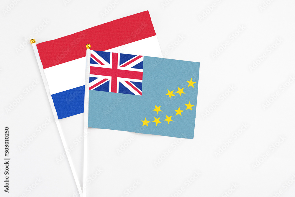 Tuvalu and Paraguay stick flags on white background. High quality fabric, miniature national flag. Peaceful global concept.White floor for copy space. Tuvalu and Paraguay stick flags on white background. High quality fabric, miniature national flag. Peaceful global concept.White floor for copy space.