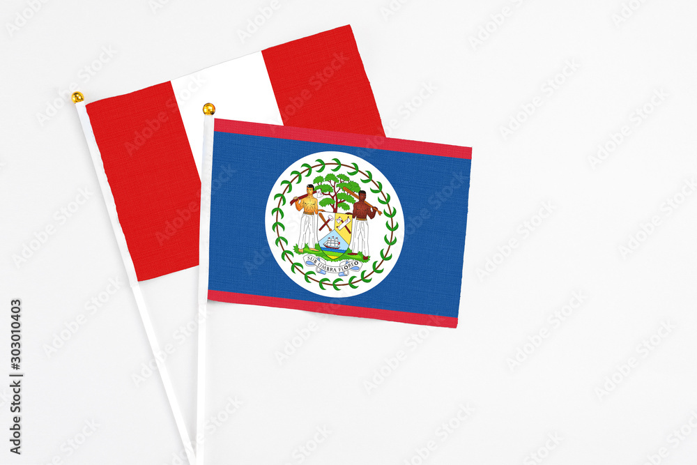 Belize and Peru stick flags on white background. High quality fabric, miniature national flag. Peaceful global concept.White floor for copy space. Belize and Peru stick flags on white background. High quality fabric, miniature national flag. Peaceful global concept.White floor for copy space.
