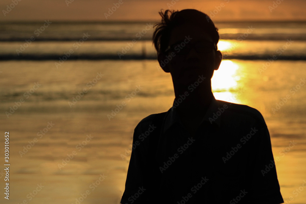 silhouette of a man on the beach at sunset