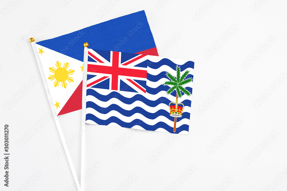 Fototapeta premium British Indian Ocean Territory and Philippines stick flags on white background. High quality fabric, miniature national flag. Peaceful global concept.White floor for copy space.