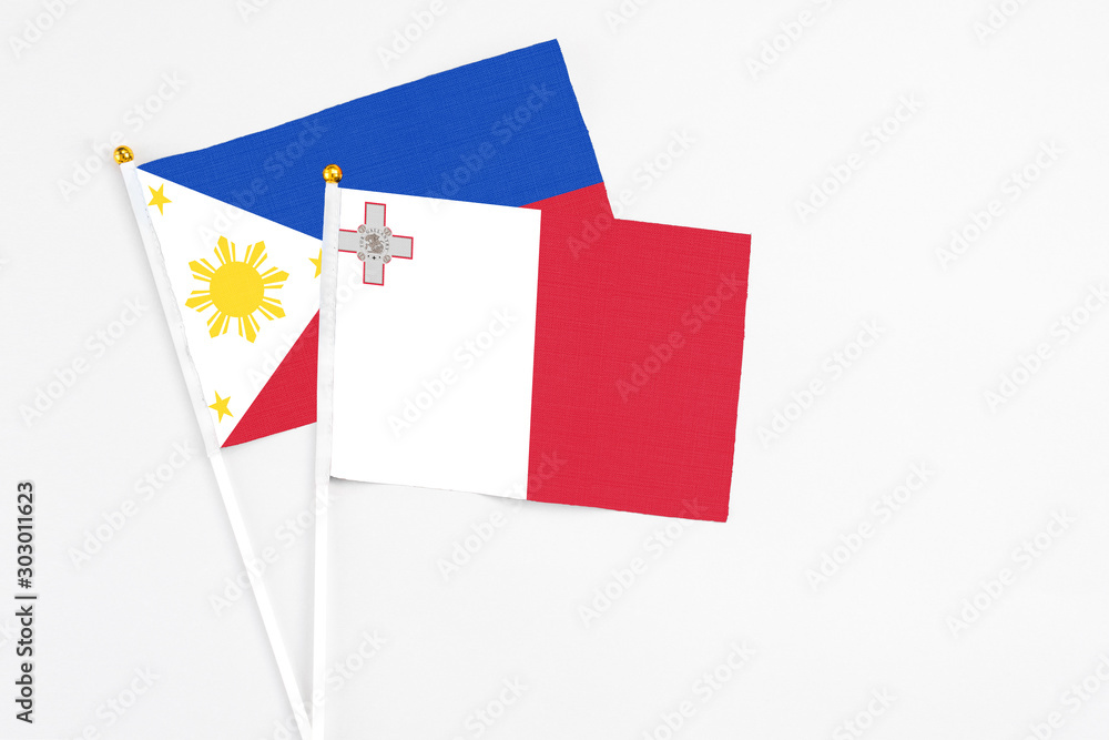 Malta and Philippines stick flags on white background. High quality fabric, miniature national flag. Peaceful global concept.White floor for copy space. Malta and Philippines stick flags on white background. High quality fabric, miniature national flag. Peaceful global concept.White floor for copy space.