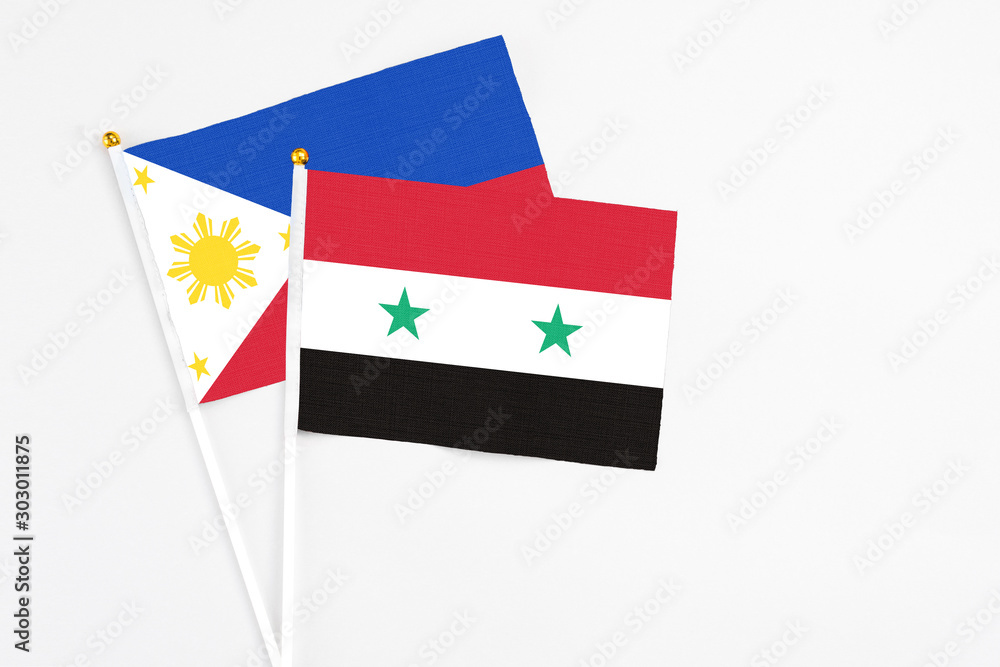 Syria and Philippines stick flags on white background. High quality fabric, miniature national flag. Peaceful global concept.White floor for copy space. Syria and Philippines stick flags on white background. High quality fabric, miniature national flag. Peaceful global concept.White floor for copy space.