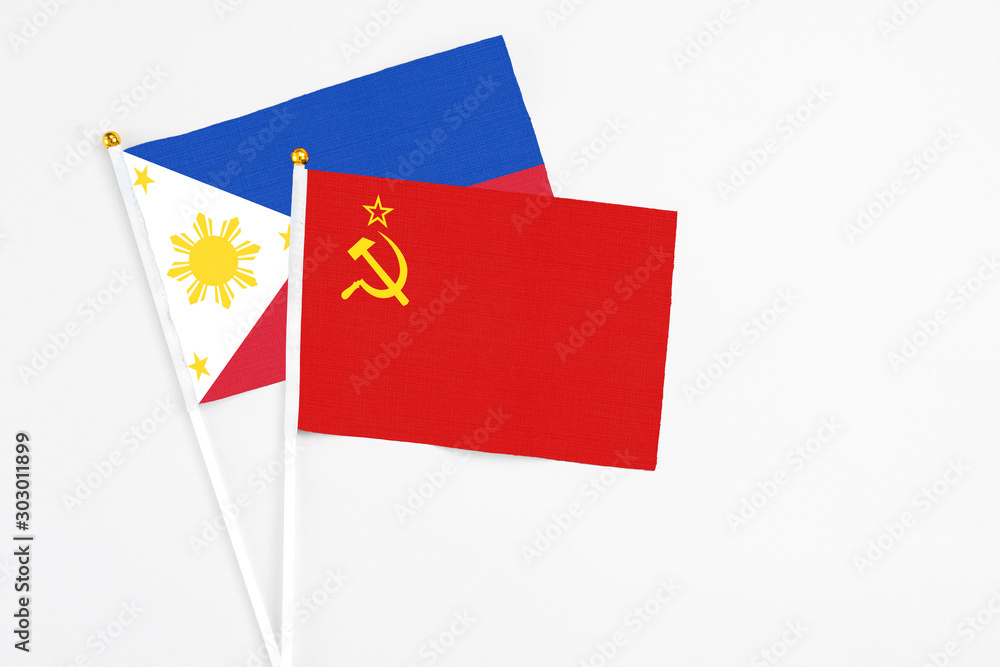 Soviet Union and Philippines stick flags on white background. High quality fabric, miniature national flag. Peaceful global concept.White floor for copy space.