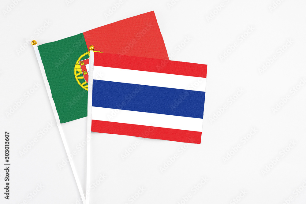 Thailand and Portugal stick flags on white background. High quality fabric, miniature national flag. Peaceful global concept.White floor for copy space. Thailand and Portugal stick flags on white background. High quality fabric, miniature national flag. Peaceful global concept.White floor for copy space.