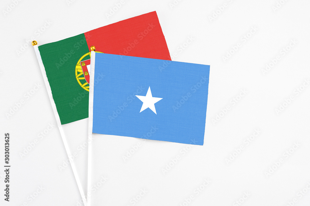 Somalia and Portugal stick flags on white background. High quality fabric, miniature national flag. Peaceful global concept.White floor for copy space. Somalia and Portugal stick flags on white background. High quality fabric, miniature national flag. Peaceful global concept.White floor for copy space.